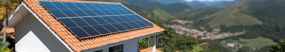 Casa com sistema de energia solar instalado no telhado, entre montanhas